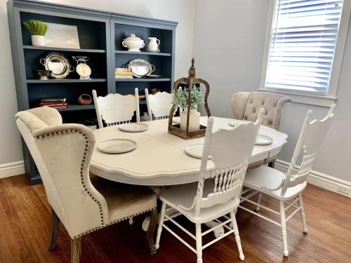 a dining room with a white table and chairs at The 1900 House 1 Block From DT in Prescott