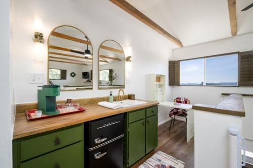 a bathroom with green cabinets and a sink at Breathtaking Views Elevated Comfort Pets Welcome in Prescott