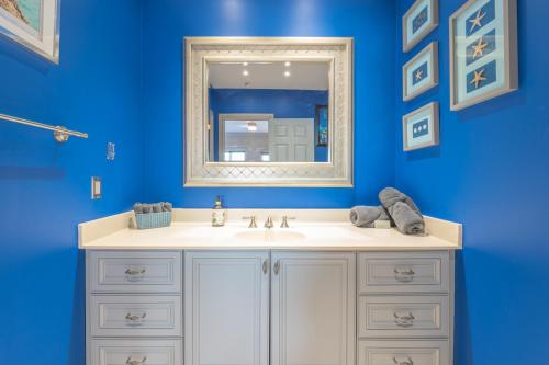 a bathroom with a white sink and a mirror at Lux Lakeside Escape Slps 20 with Pool, Golf Sim, Hot Tub, Karaoke, Gym and Sauna in Peterborough