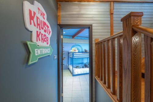 a door to a room with a bed in a house at Lux Lakeside Escape Slps 20 with Pool, Golf Sim, Hot Tub, Karaoke, Gym and Sauna in Peterborough