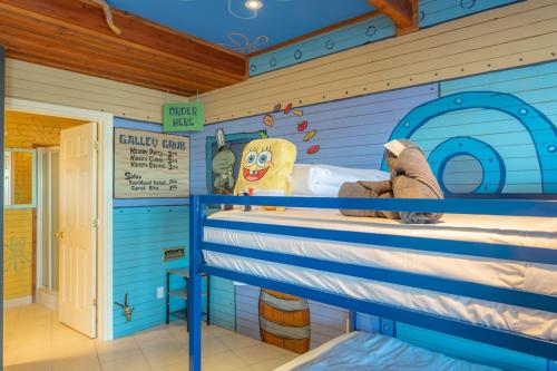 a room with a bunk bed in a house at Lux Lakeside Escape Slps 20 with Pool, Golf Sim, Hot Tub, Karaoke, Gym and Sauna in Peterborough
