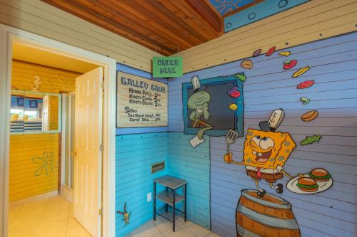 a wall in a house with a cartoon character in the door at Lux Lakeside Escape Slps 20 with Pool, Golf Sim, Hot Tub, Karaoke, Gym and Sauna in Peterborough