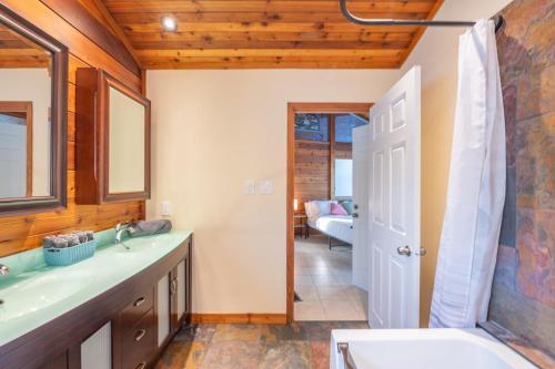 a bathroom with a sink and a bath tub at Lux Lakeside Escape Slps 20 with Pool, Golf Sim, Hot Tub, Karaoke, Gym and Sauna in Peterborough