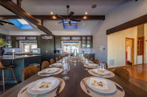 a large dining room with a long table with chairs at Lux Lakeside Escape Slps 20 with Pool, Golf Sim, Hot Tub, Karaoke, Gym and Sauna in Peterborough