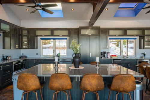 a kitchen with a large island with a counter top at Lux Lakeside Escape Slps 20 with Pool, Golf Sim, Hot Tub, Karaoke, Gym and Sauna in Peterborough