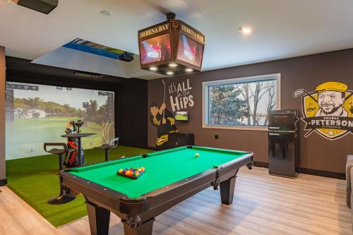 a billiard room with a pool table and a sign at Lux Lakeside Escape Slps 20 with Pool, Golf Sim, Hot Tub, Karaoke, Gym and Sauna in Peterborough