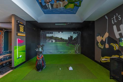 a golf room with a display of a golf course at Lux Lakeside Escape Slps 20 with Pool, Golf Sim, Hot Tub, Karaoke, Gym and Sauna in Peterborough