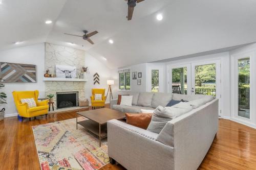 a living room with a couch and a fireplace at Spacious property with Pool and walkable to downtown in Pinehurst