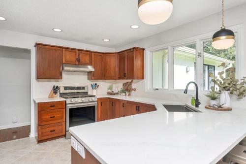 a kitchen with wooden cabinets and a white counter top at Spacious property with Pool and walkable to downtown in Pinehurst