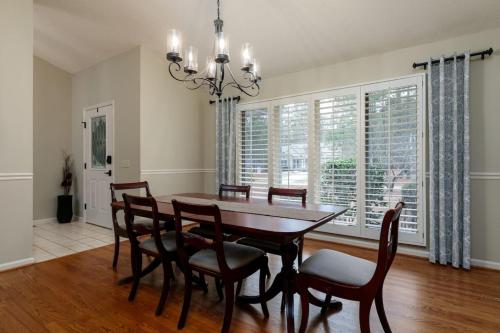 a dining room with a table and chairs and a chandelier at Pinehurst No. 6 Golf Front Getaway in Pinehurst