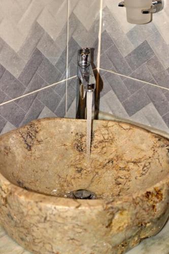 a sink with a faucet in a bathroom at Chaska Hotel in Otavalo