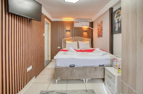 a bedroom with a bed and a tv on a wall at Cendere Old City Hotel in Istanbul