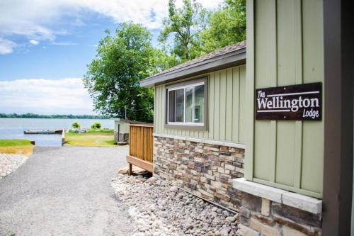 a building with a sign on the side of it at Westlake Cottage - Wellington Lodge in Wellington