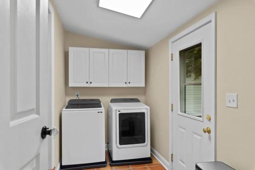 a kitchen with a white refrigerator and a window at Downtown Village of Pinehurst 2BR 2BA in Pinehurst