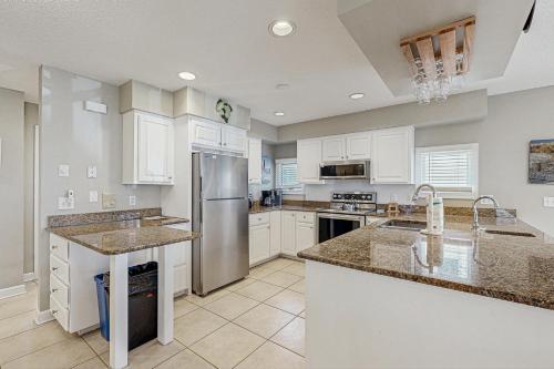 a kitchen with white cabinets and a stainless steel refrigerator at Town of Bethany Beach -116 Oakwood St in Bethany Beach