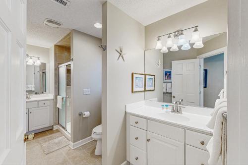a white bathroom with a sink and a toilet at Town of Bethany Beach -116 Oakwood St in Bethany Beach