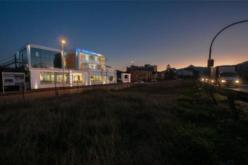 a building with lights on in a city at night at Hotel Testani Frosinone in Frosinone