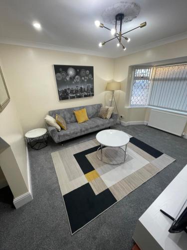 a living room with a couch and a table at Luxury 2 bed house and Pool table in Harborne in Birmingham