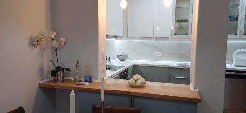 a kitchen with white cabinets and a wooden counter top at Lxroller Seomara Apartment 3 Bdr in Amadora