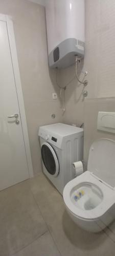 a bathroom with a toilet and a washing machine at Apartman Marija in Trogir