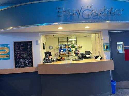 a restaurant with a counter and a sign on the wall at The Lodge Inn in Edmonton