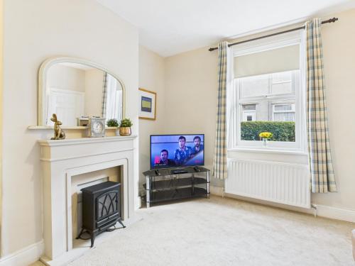 a living room with a tv and a fireplace at RestfullStays- 3 Bedroom, 4 Bed House FREE PARKING in Whitley Bay
