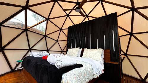 a room with a bed in a triangular shaped room at La Julita Glamping in La Mesa