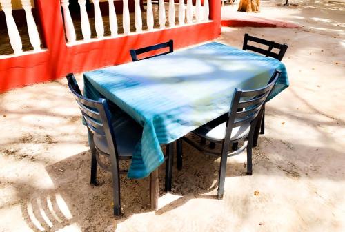 a table with chairs and a blue table cloth on it at Kuba Lodge in Gunjur