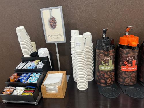 a table with stacks of plates and a box of food at Wingate by Wyndham Sioux City in Sioux City