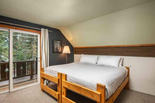 a bedroom with a bed and a large window at Mt. Hood Chalet in Government Camp