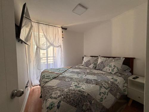 a bedroom with a bed and a window at Apartment in Santiago-Catedral in Santiago
