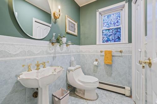 a bathroom with a sink toilet and a mirror at Big House, Hot tub, Very large backyard in Stony Point
