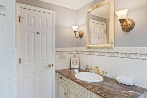 a bathroom with a sink and a mirror at Big House, Hot tub, Very large backyard in Stony Point
