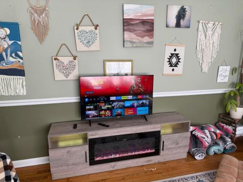 a living room with a flat screen tv on a wooden entertainment center at Big House, Hot tub, Very large backyard in Stony Point