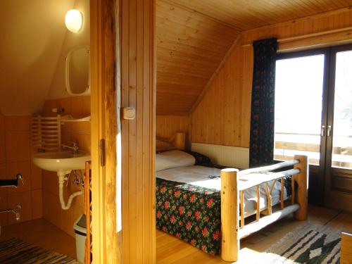 a bedroom with a bunk bed in a wooden house at Chata Pod Grapom in Czarna Góra