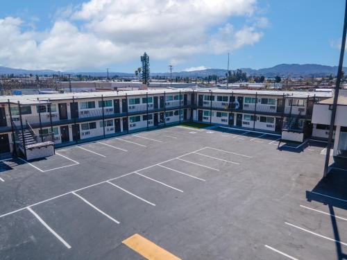 an empty parking lot in front of a building at Inland Inn & Suites in San Bernardino