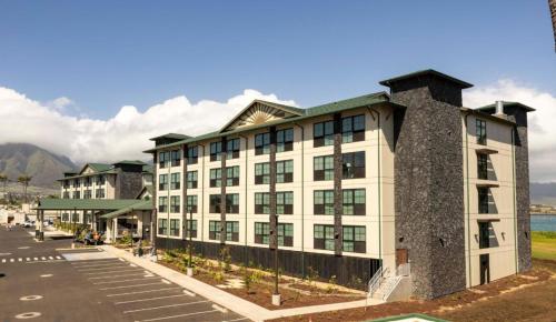 a rendering of a building with mountains in the background at Hampton Inn & Suites Maui North Shore in Kahului