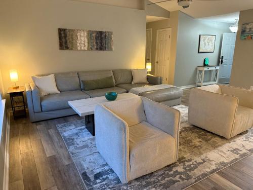 a living room with a couch and two chairs at The Crestview Beach House in Crestview