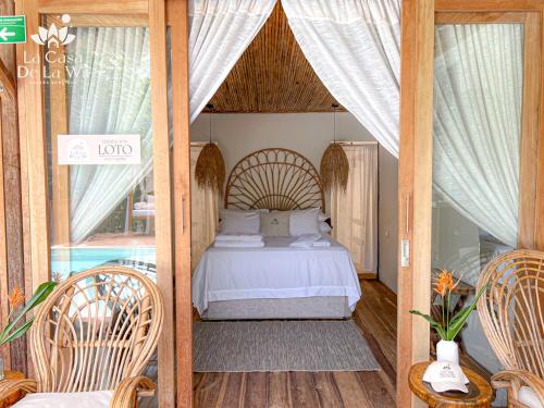 a bedroom with a bed with a canopy at Habitacion Luxury Loto en La casa de la Wii en Mendihuaca, a 10 minutos del Parque Tayrona in Santa Marta