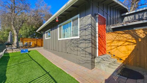a house with a red door on the side of it at Peaceful Yosemite Retreat-King Suite-Pet Friendly in Oakhurst