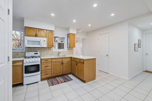 a kitchen with wooden cabinets and white appliances at House for groups Wifi -Hot Tub in Stony Point