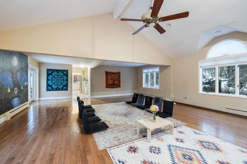 a living room with a ceiling fan and a couch at House for groups Wifi -Hot Tub in Stony Point