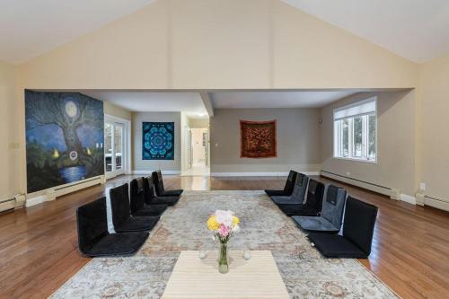 an empty living room with black chairs and a table at House for groups Wifi -Hot Tub in Stony Point