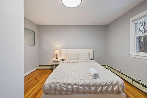 a bedroom with a large bed with a white bedspread at House for groups Wifi -Hot Tub in Stony Point