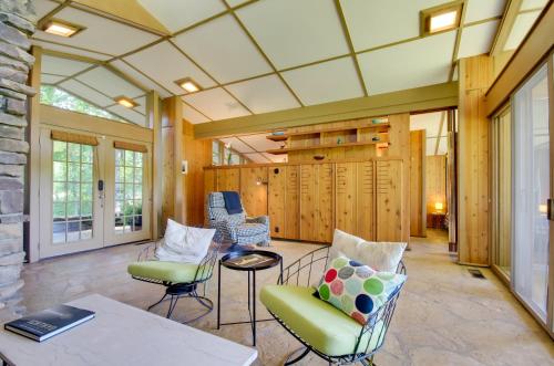 a living room with chairs and a table at Tranquil Mid-Century Modern Cottage with Forest View in Hardy