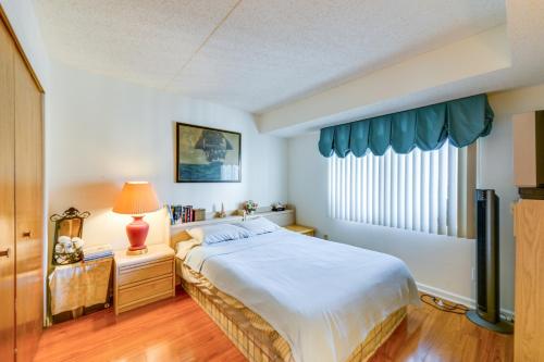 a bedroom with a large bed and a window at Atlantic City Area Vacation Rental with Pool Access! in Brigantine