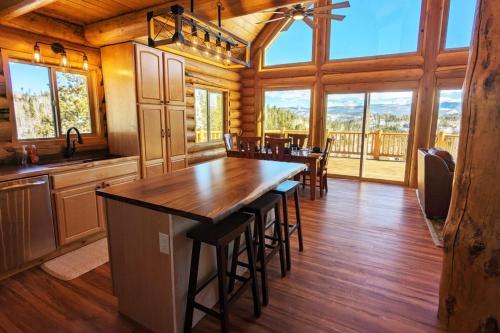 a large kitchen with a large island in a log cabin at New Log Home, Hot Tub For 8, Views! in Tabernash