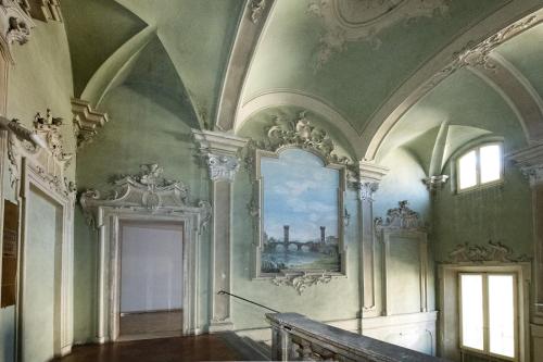 an ornate hallway with a painting on the wall at Amazing Serenity Flat for 7, AC, historic center in Faenza
