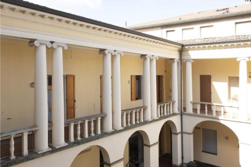 a row of columns on a building at Amazing Serenity Flat for 7, AC, historic center in Faenza