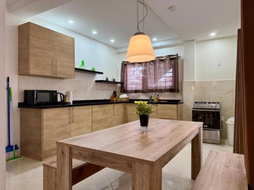 a kitchen with a wooden table with a vase on it at 2 Slaapkamer Appartement in Paramaribo-Noord in Paramaribo